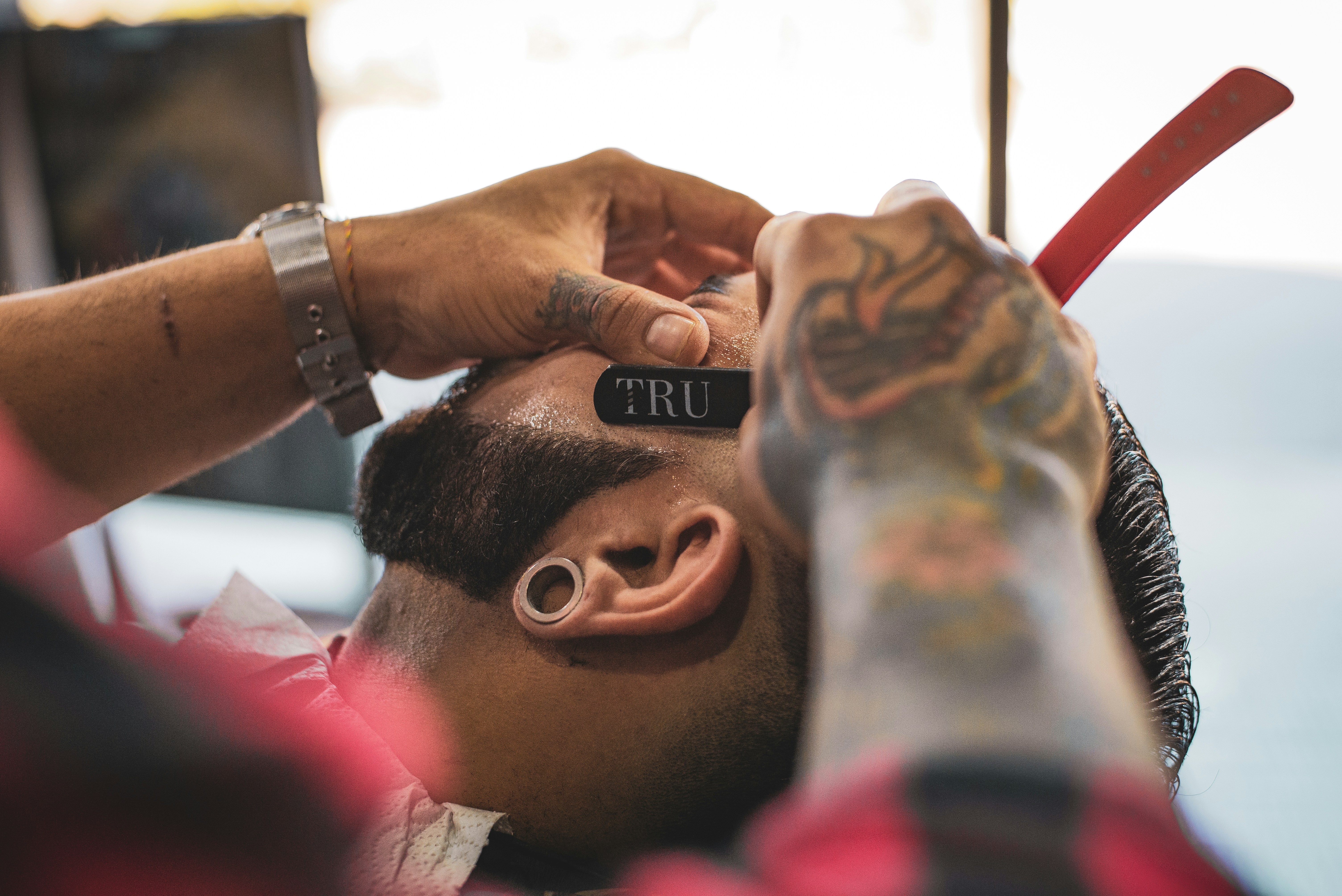 Barber having a shave on beard